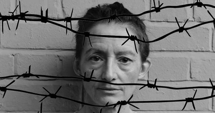 Woman behind barbed wire